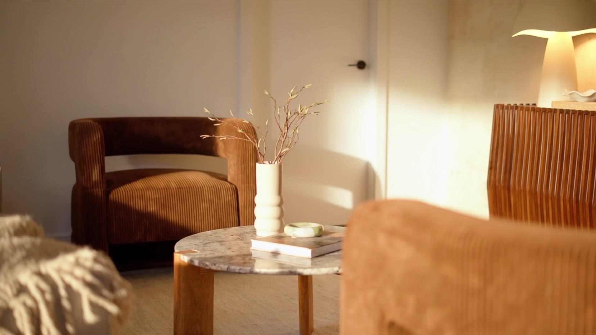 Interior of a Madina project — still life with lamp, artwork and cabinetry